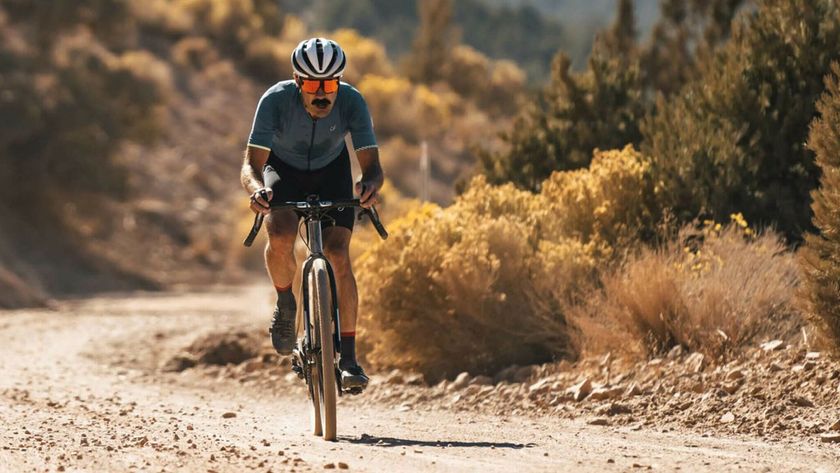 A rider wearing the best gravel bike shorts while riding a dry gravel track