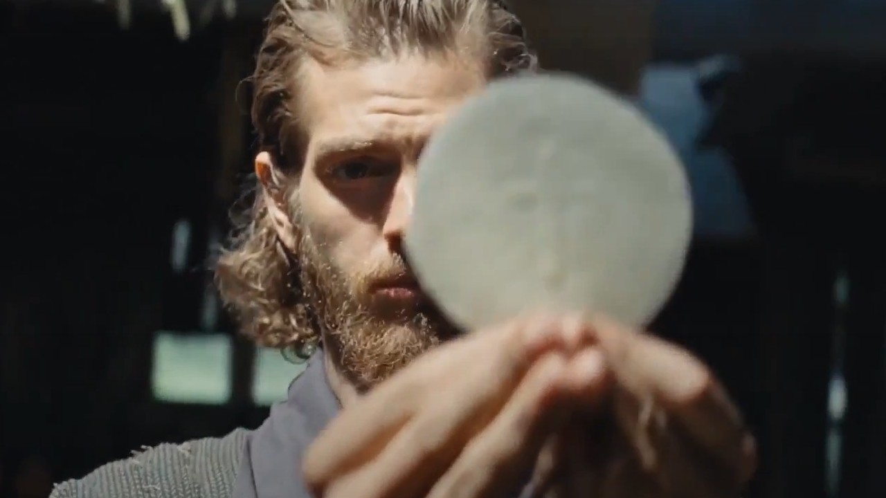 Andrew Garfield with his face partially covered by the Eucharist in Silence