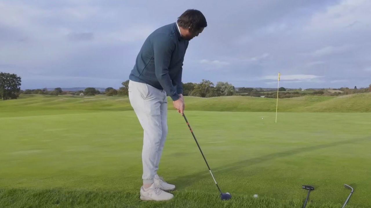 Photo of Joe Ferguson addressing a 3 wood from the rough