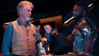 Pierce Brosnan and Aldis Hodge sharing a fist bump in Black Adam.