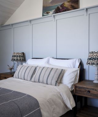 Neutral bedroom with panelling in Cornish coastal newbuild
