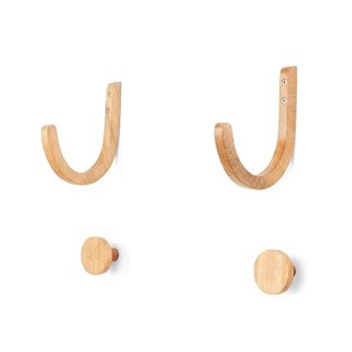A set of wooden yoga mat hooks and holders