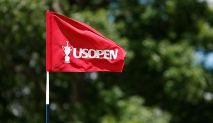 A US Open flag flutters in the wind