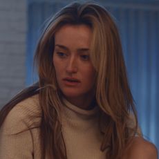 Carolyn Bessette-Kennedy in FX's Love Story wearing J.Crew's iconic rollneck sweater with John F. Kennedy Jr.