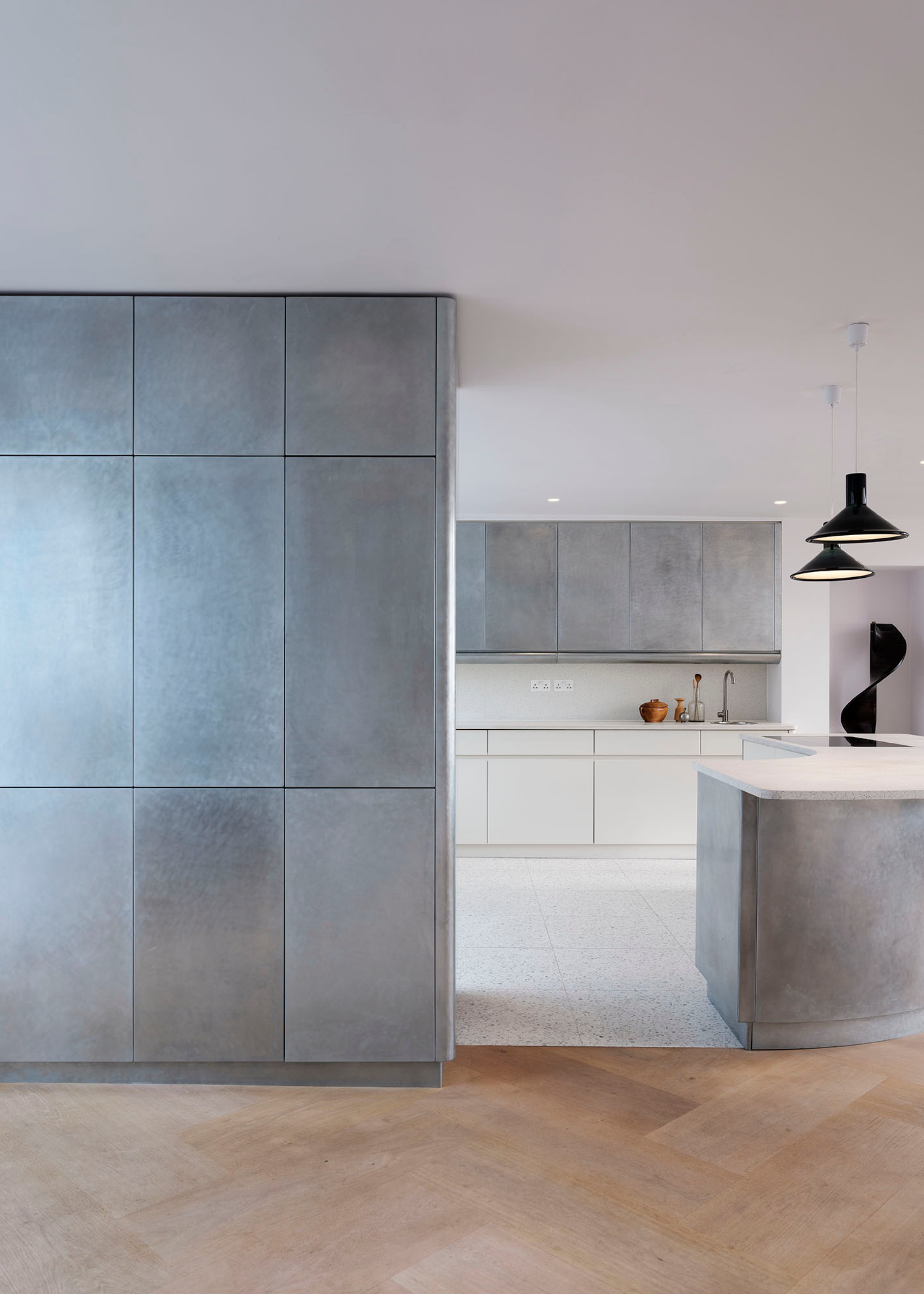 simple, modern kitchen with sanded steel cabinets and white floors