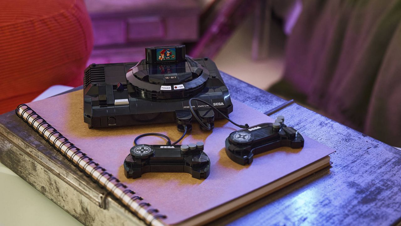 Lego Sega Genesis and 2 controllers on a notepad, which lies on a metal box