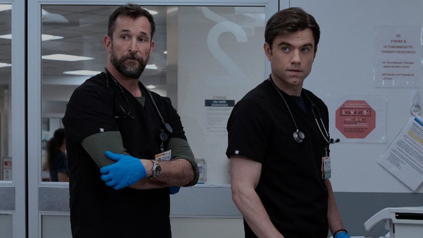 From left to right: Noah Wyle crossing his arms as Dr. Robby and Patrick Ball as Langdon standing next to him. 