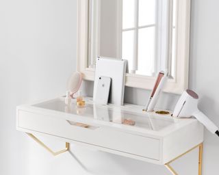 Get Ready Beauty Station from Pottery Barn Teen in white with beauty, hair, and tech products scattered throughout