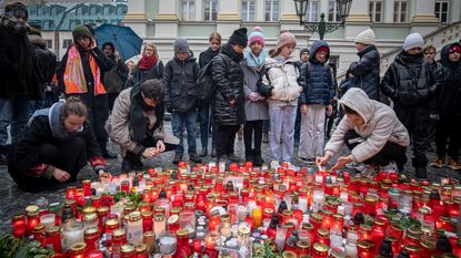Mourners light candles in Prague for those killed in deadly mass shooting