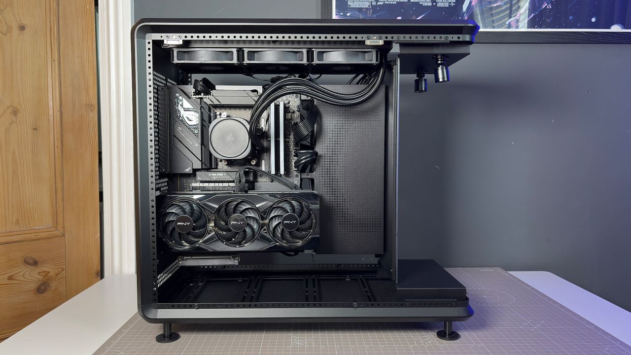 The CoolerMaster MasterFrame 360 Panoramic PC case with various components installed on a desk.