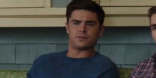 Zac Efron sitting on a porch in Neighbors