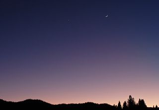 The crescent moon and Venus shine near each other on Dec. 26, 2011 during a bright conjunction captured here by skywatcher David Smoyer of Truckee, Calif.