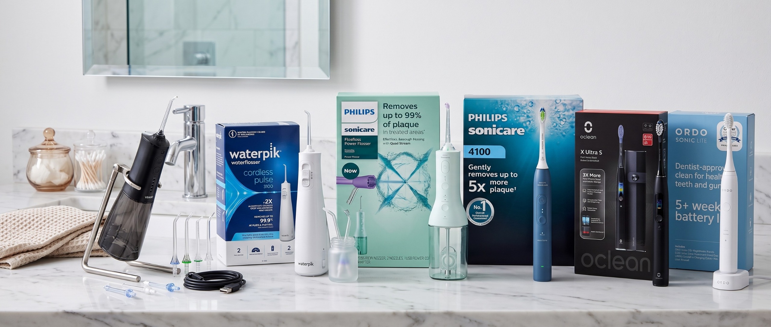 Selection of water flossers and electric toothbrushes arranged in a typical bathroom setting. 