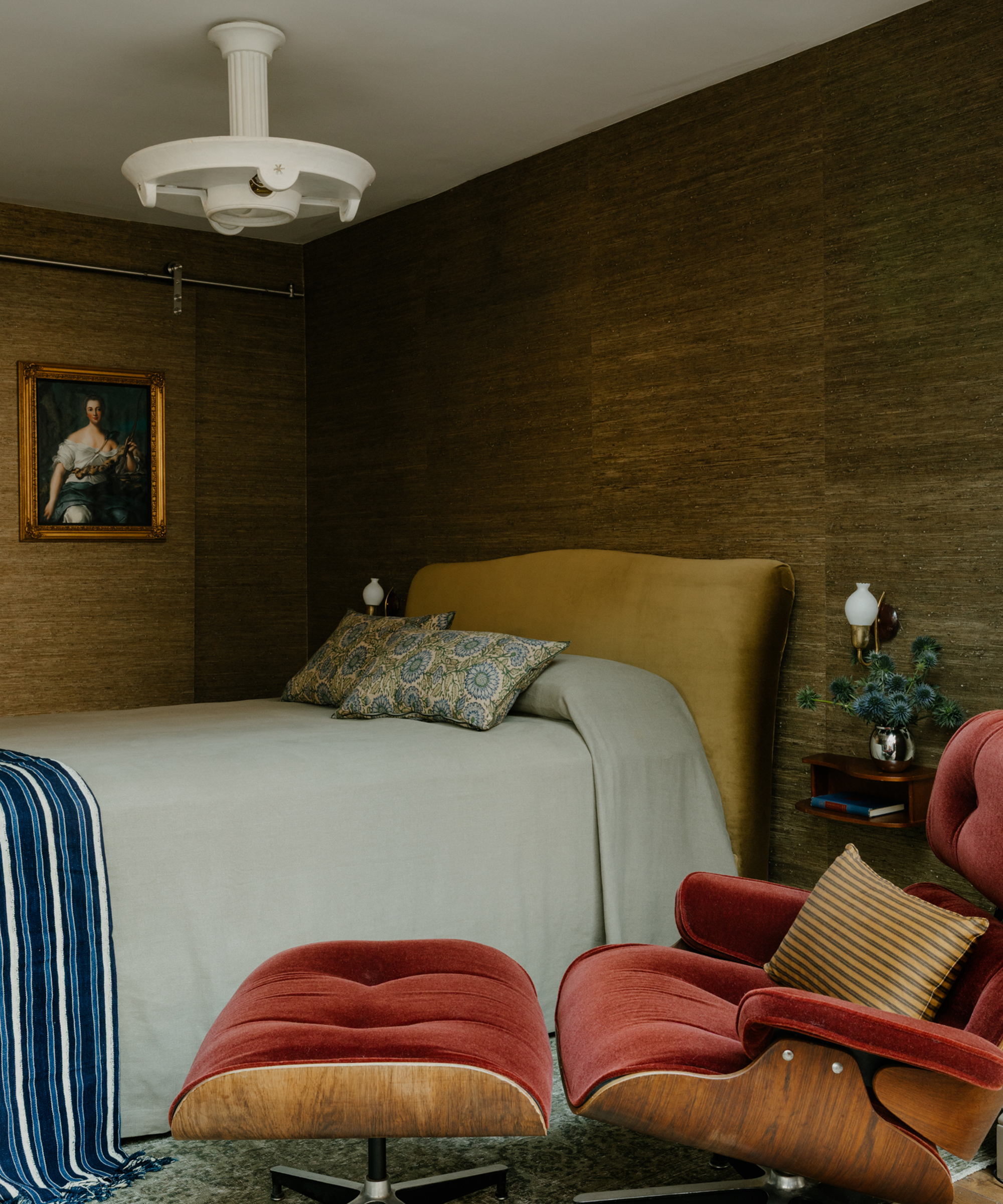 bedroom with red chair and yellow headboard