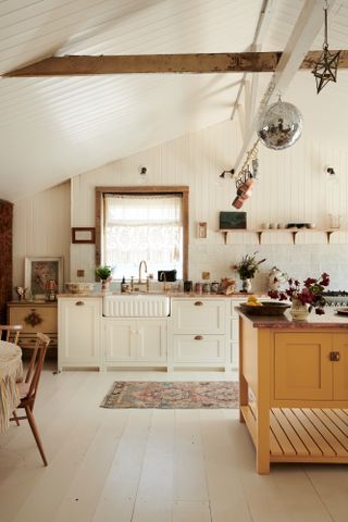 White and yellow kitchen by deVOL