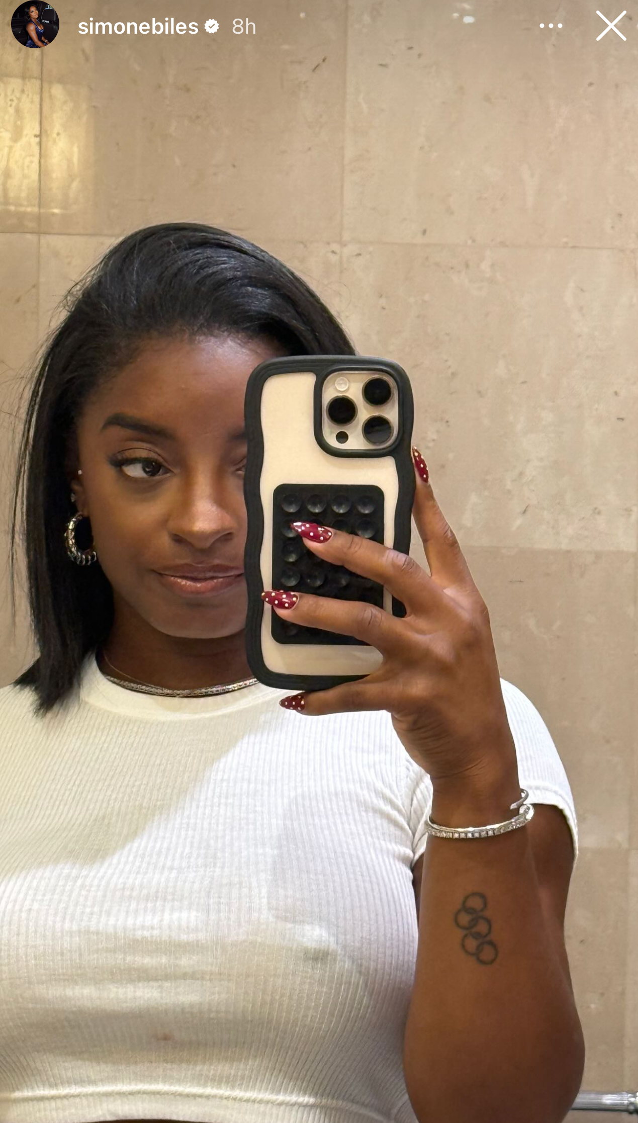 simone biles wearing a red manicure with white polka dots