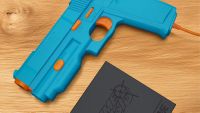 A blue retro lightgun on a wooden table