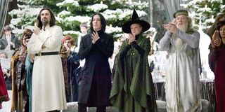 Karkaroff, Snape, McGonagal and Dumbledore stand and clap at the Yule Ball in Harry Potter and the G