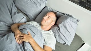 Man sleeping peacefully on his back with his mouth closed