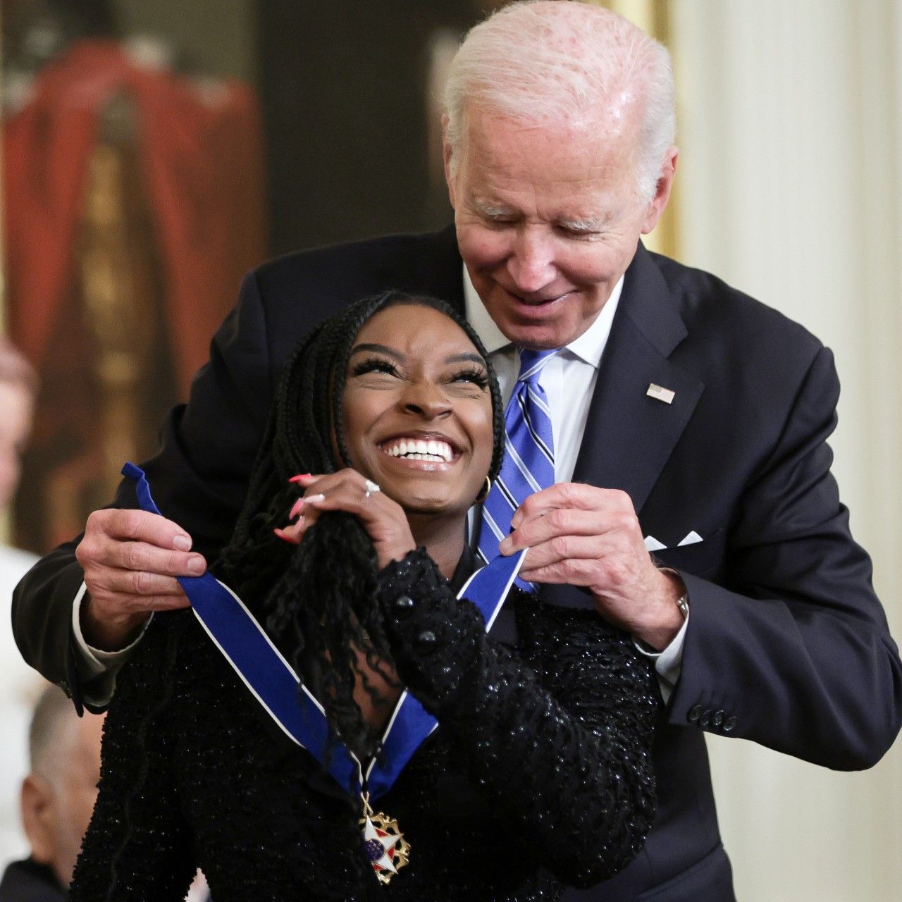 U.S. President Joe Biden presents the Presidential Medal of Freedom to Simone Biles, Olympic gold medal gymnast and mental health advocate, during a ceremony in the East Room of the White House July 7, 2022 in Washington, DC. President Biden awarded the nation's highest civilian honor to 17 recipients. The award honors individuals who have made exemplary contributions to the prosperity, values, or security of the United States, world peace, or other significant societal, public or private endeavors.