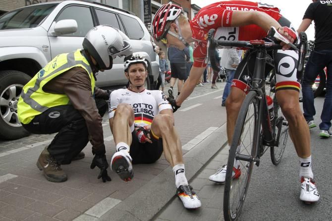 Marcel Sieberg checks on Lotto Belisol teammate Andre Greipel who crashed in the final kilometres