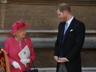 Prince Harry and Her Royal Majesty the Queen smiling and laughing together.