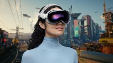Apple Vision Pro worn by lady with screenshot of Cyberpunk 2077 in the background