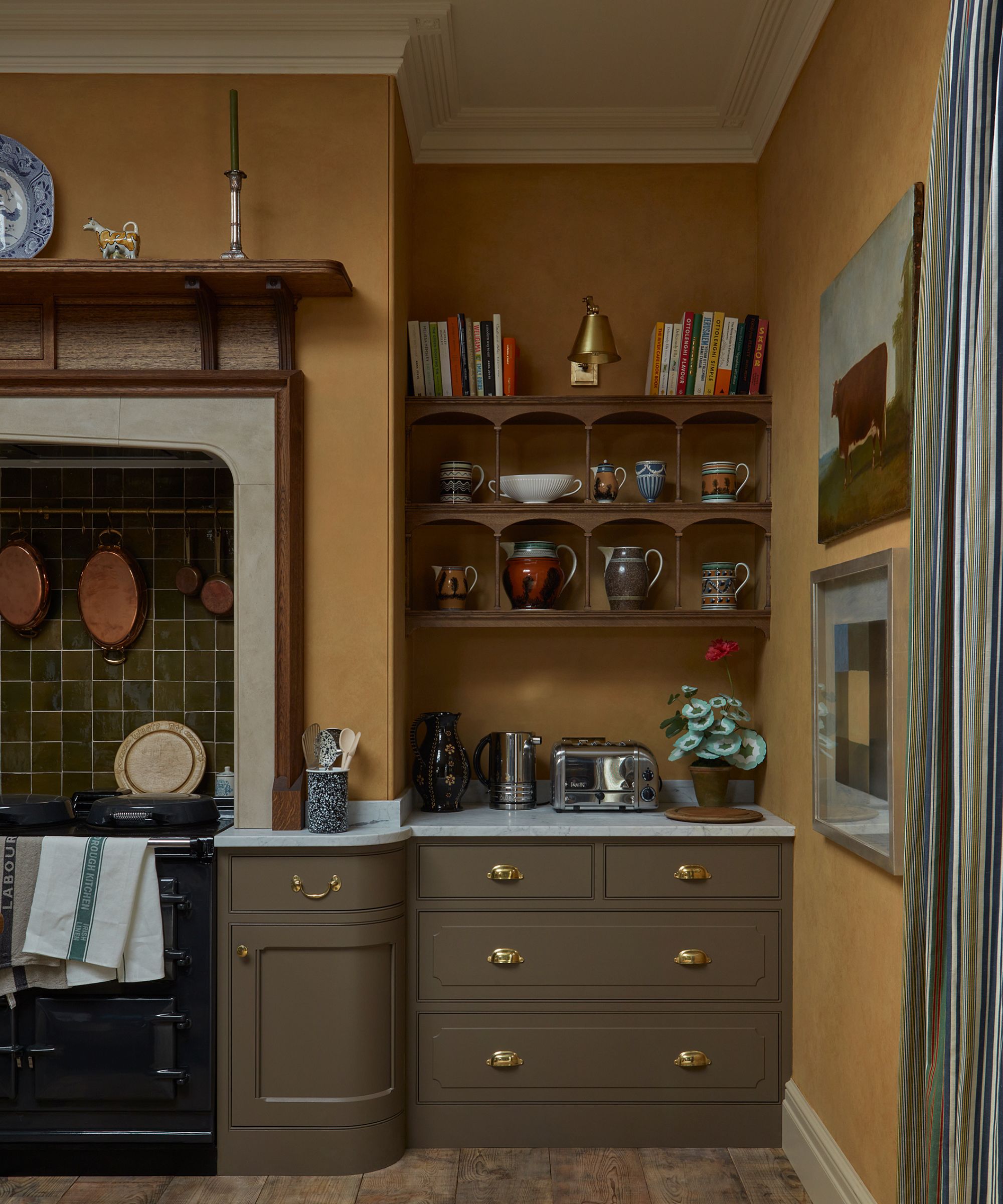 A traditional kitchen with mustard colored walls and moleskin brown cabinetry