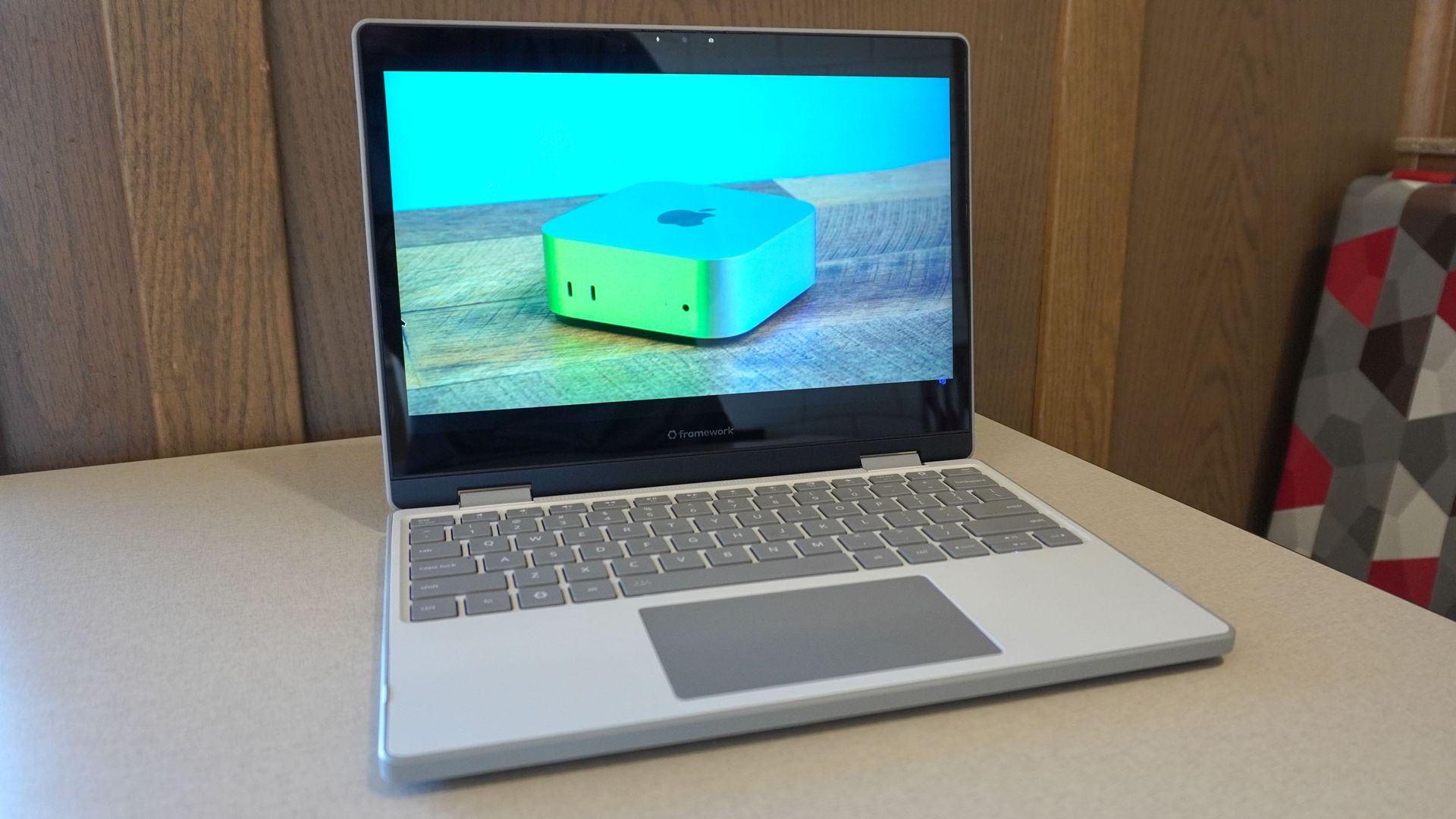 The Framework Laptop 12 open on a table showing a video from Tom's Guide's YouTube channel