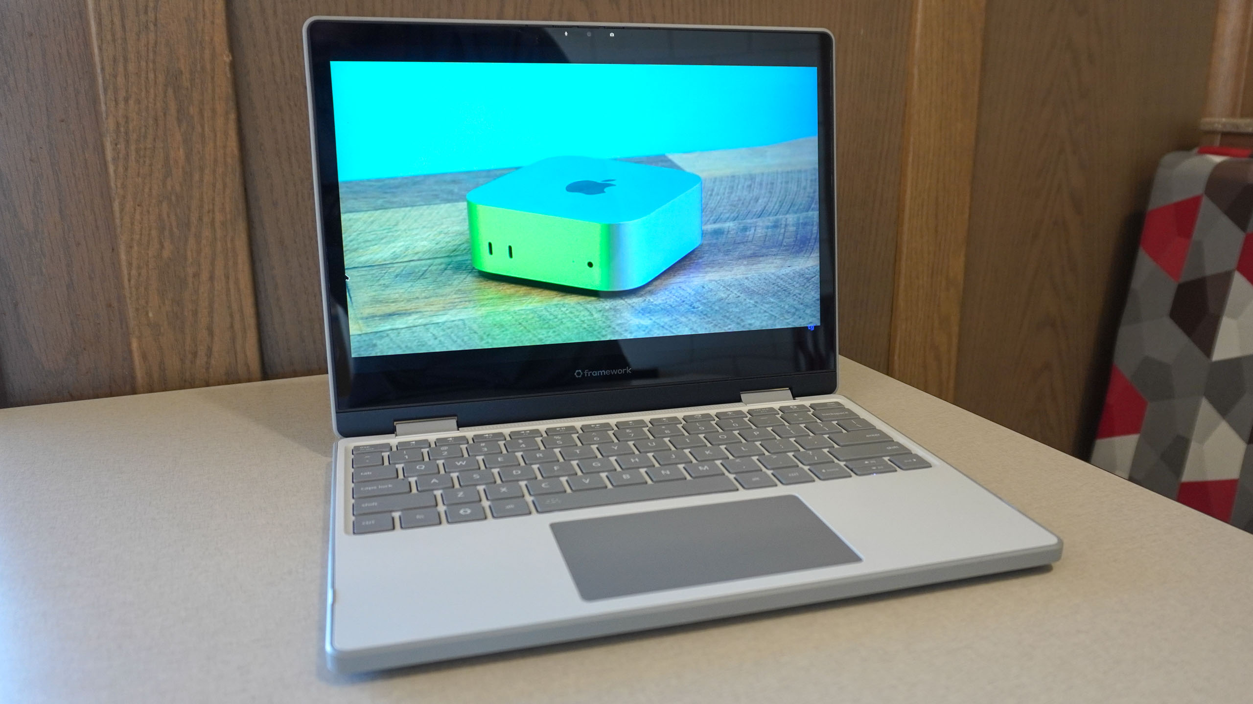 The Framework Laptop 12 open on a table showing a video from Tom's Guide's YouTube channel