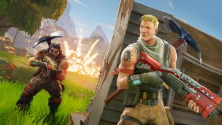 Fortnite screenshot showing one character with an assault rifle hiding behind a created cover as an enemy approaches