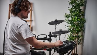 Man using module of Yamaha DTX6 electronic drum set