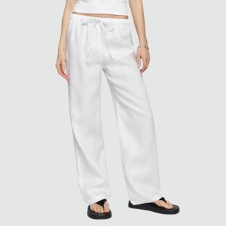 model wearing white linen trousers from reformation