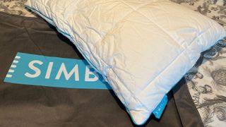 The Simba Stratos Pillow on top of its storage bag