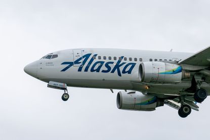 Image of Alaska Airlines&#039; Boeing 787-790 aircraft flying at Anchorage airport