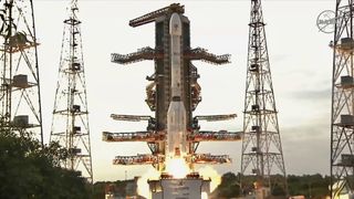 A white rocket with fat bottom lifts off