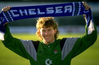 Dave Beasant holds a Chelsea scarf above his head after signing for the Blues in 1989.