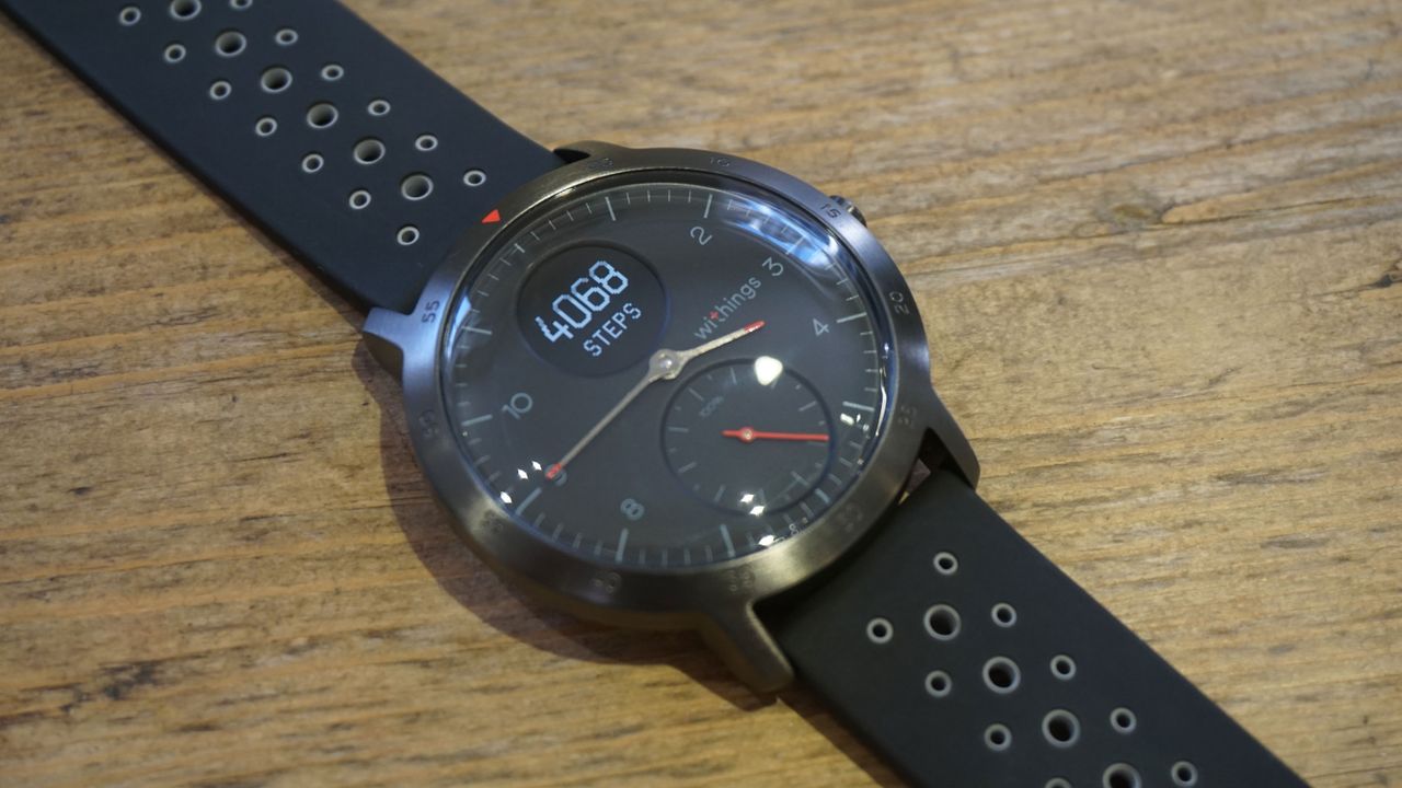 The Withings Steel HR Sport pictured on a wooden surface.