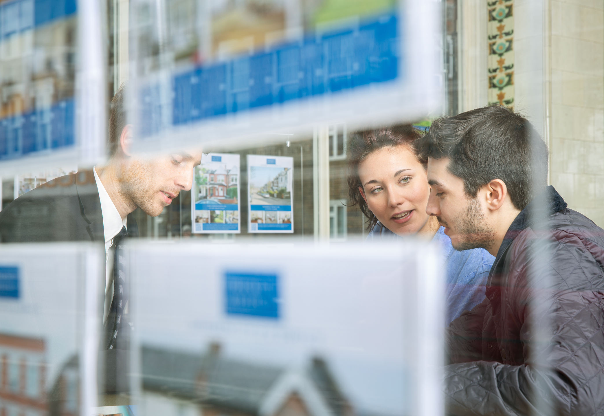 Couple talking with an estate agent