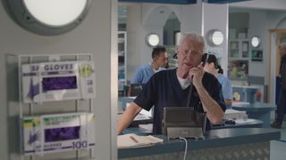 Worried Charlie in Casualty on the phone at work