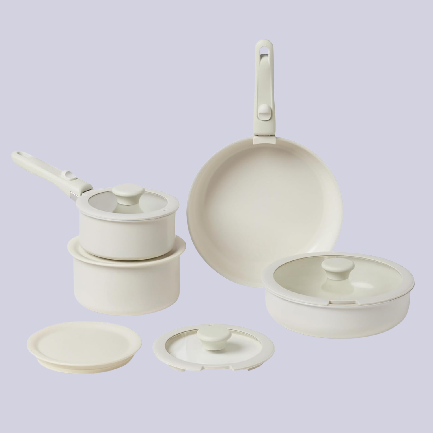 A set of white pots and pans with detachable handles and lids