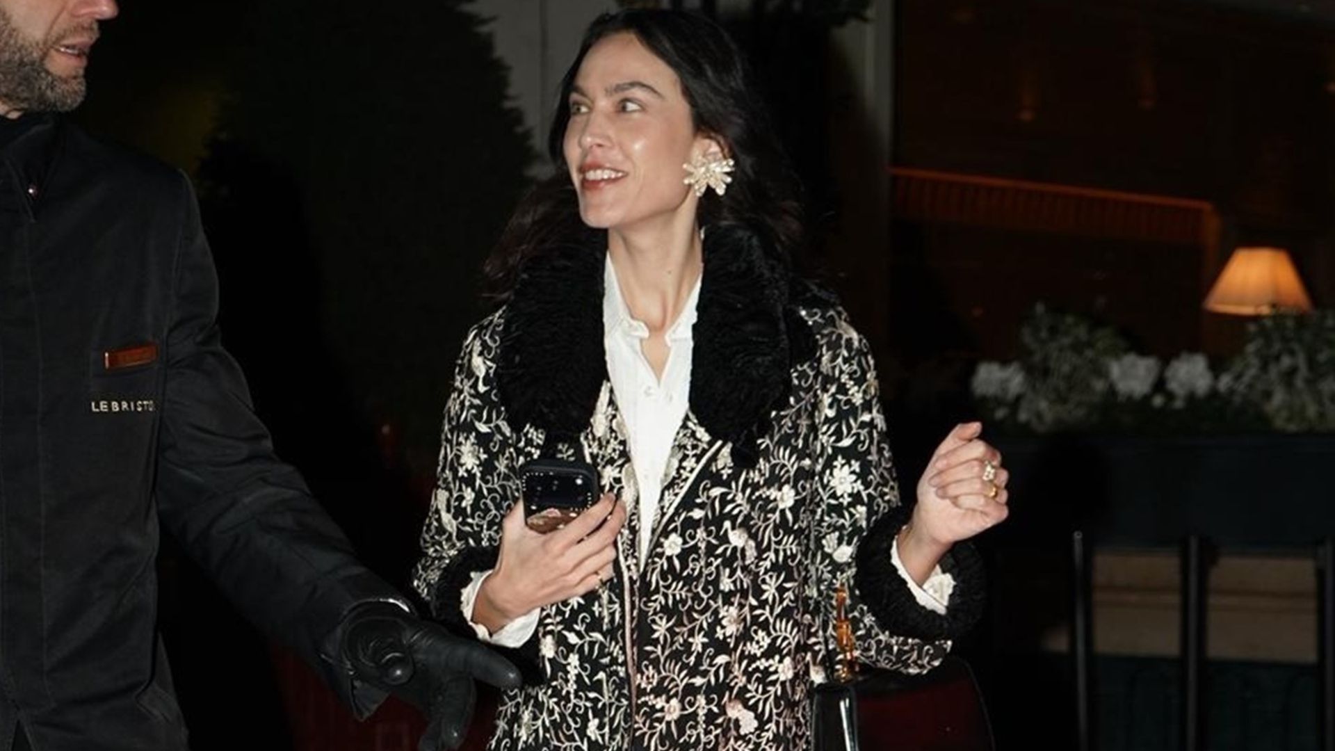 Alexa Chung wears an ornate jacket with straight-leg jeans, lilac heels and oversized earrings.