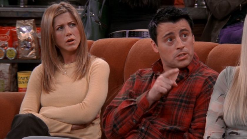Rachel (Jennifer Aniston) and Joey (Matt LeBlanc) sit on the orange couch in Central Perk on Friends.