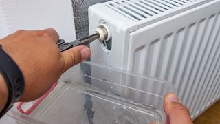 Turning valve and catching water from bleeding a radiator