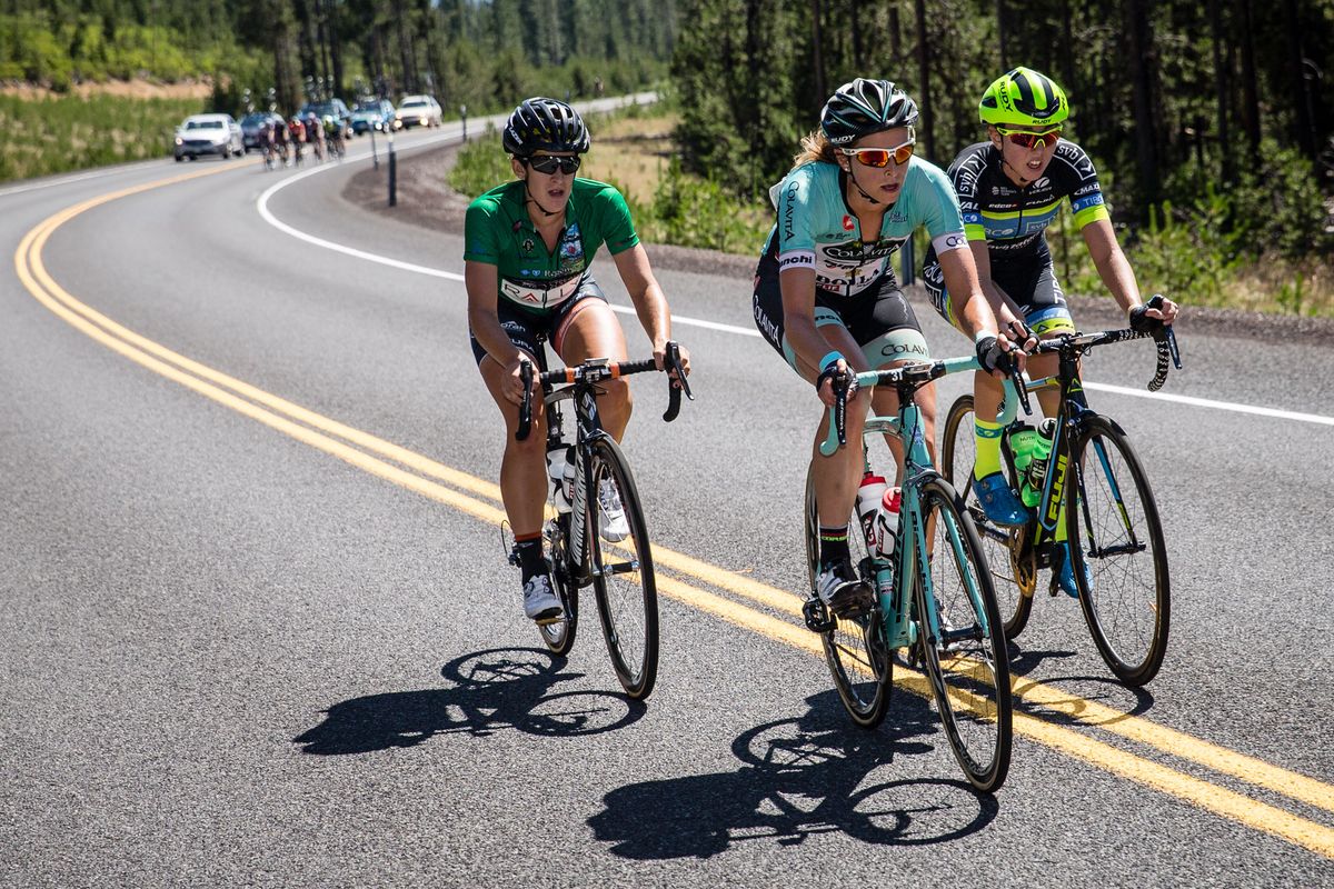 Three riders break away from the lead group on the climb
