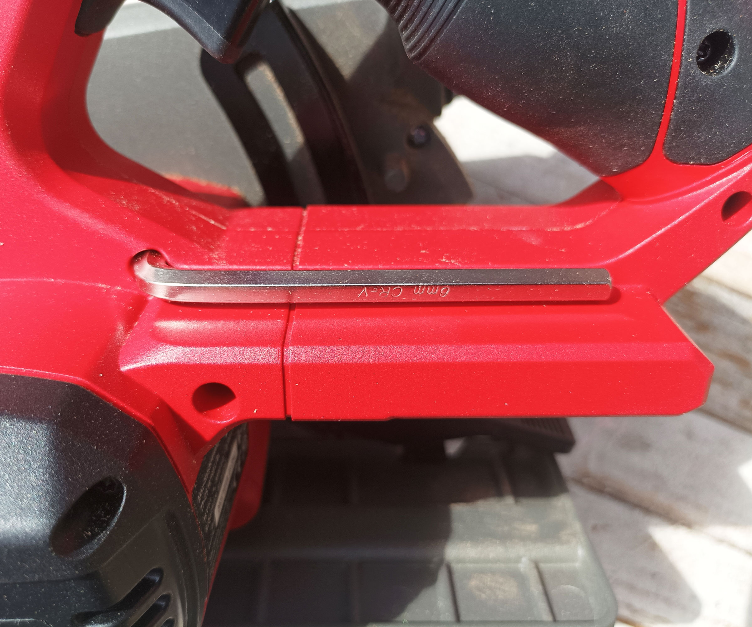 Saw blade wrench integrated into red handle on Einhell circular saw