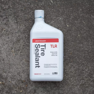 A bottle of Bontrager TLR Tyre Sealant on a concrete background