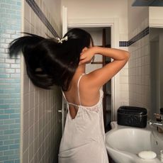 Woman flipping her long black hair over her shoulders
