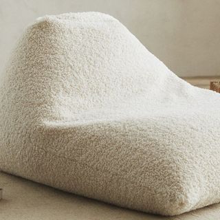 A white faux shearling pouf chair that's a part of Zara Home's summer sale.