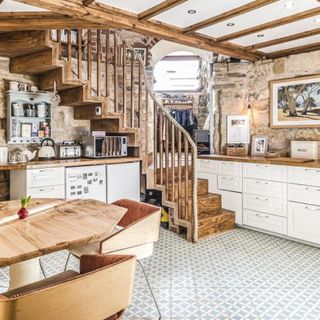 kitchen room with wooden staircase and wooden table chair